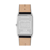 The back view of a Coach wristwatch with a silver stainless steel case and a light brown leather strap, showing technical specifications printed on the metal.