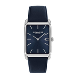 A Coach New York wristwatch with a navy blue sunburst dial, silver-tone rectangular case, and a matching navy blue leather strap, shown against a plain white background.