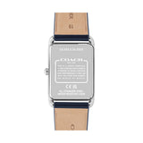 The back view of a Coach wristwatch with a silver stainless steel case and a light brown leather strap, showing technical specifications printed on the metal back.