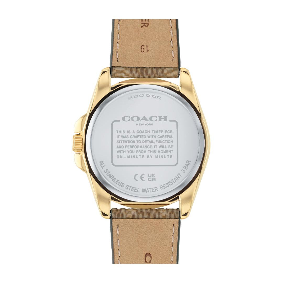 The back view of a Coach watch with a gold-toned case and a light brown leather strap, showing the detailed specifications printed on the back of the case.
