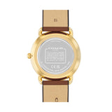 The back view of a Coach wristwatch with a gold-toned metal case and a brown leather strap, shown on a plain white background.