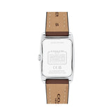The back view of a Coach wristwatch with a silver stainless steel case and a brown leather strap, showing the brand name and specifications engraved on the case.