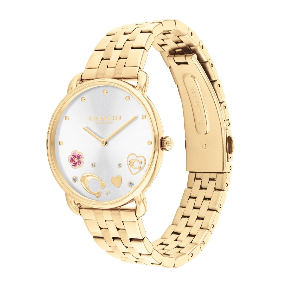 A gold-tone stainless steel watch with a white dial, featuring gold-tone hands, a small pink flower, and heart-shaped markers on a clean white background.