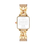 The back view of a Coach women's watch featuring a gold-tone case, a chunky gold-tone chain link bracelet, and a light beige leather strap, shown on a plain white background.