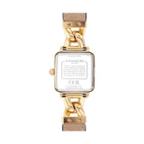 The back view of a Coach women's watch featuring a gold-tone case, a chunky gold-tone chain link band, and a white dial showing technical specifications.