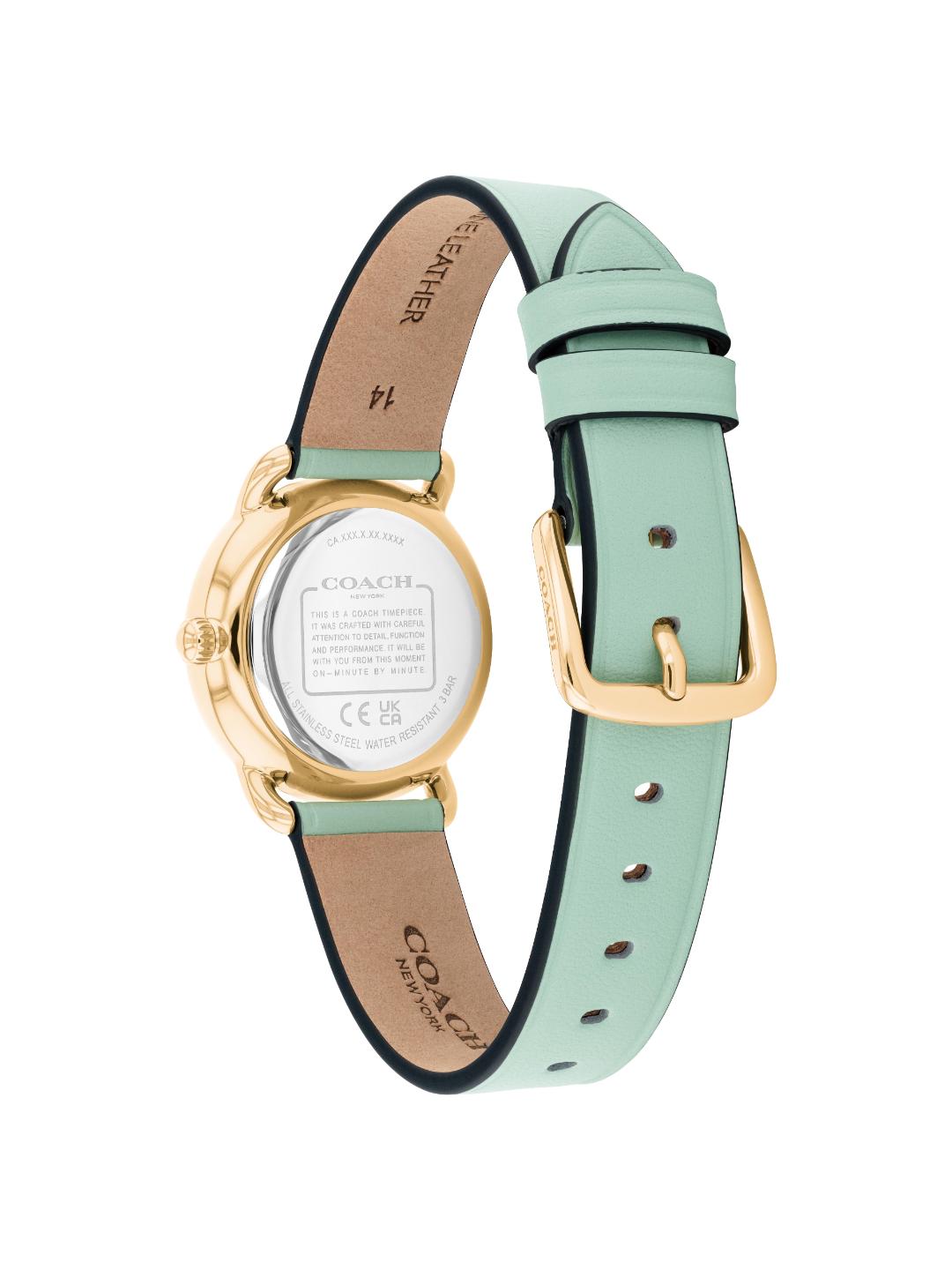 A Coach women's watch shown from the back, featuring a light mint green leather strap with a gold-tone buckle and case, and a tan leather interior.