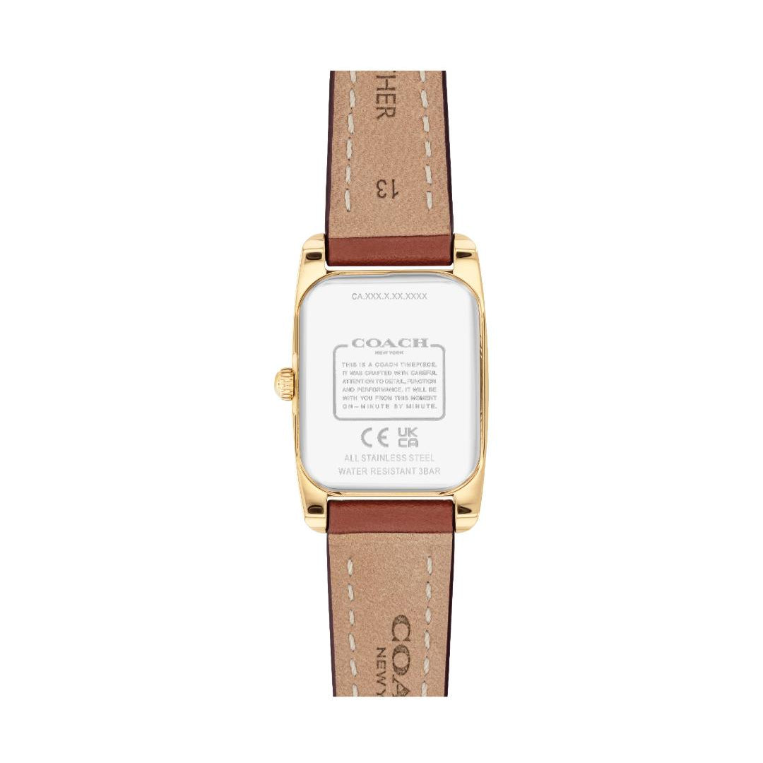 The back view of a Coach wristwatch with a gold-tone case and a brown leather strap featuring white stitching and Coach branding.