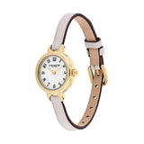 A Coach women's watch with a slim white leather strap, gold-tone case, and white dial with black Arabic numerals.