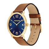 A Coach women's analog watch with a deep blue sunburst dial, gold-tone case, and a brown leather strap with a tan interior, shown on a plain white background.