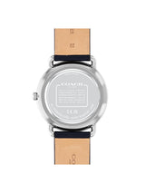 The back view of a Coach wristwatch with a silver stainless steel case and a light tan leather strap, shown on a plain white background.