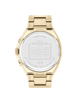 The back view of a Coach stainless steel watch with a gold-tone case and integrated link bracelet, showing engraved specifications on the crystal.