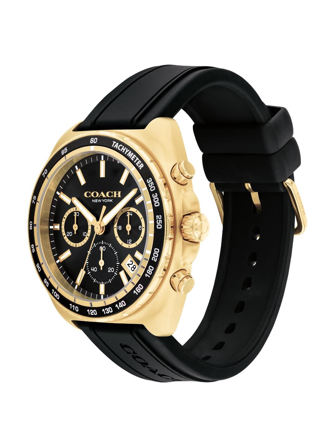 Coach New York wristwatch with a gold-tone case, black dial, and black rubber strap, shown on a plain white background.