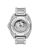 The back view of a stainless steel wristwatch with a transparent case back showing the mechanical movement inside, on a solid white background.