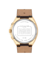 The back view of a Coach New York wristwatch with a gold-tone case and a brown leather strap, showing the detailed specifications printed on the back glass.