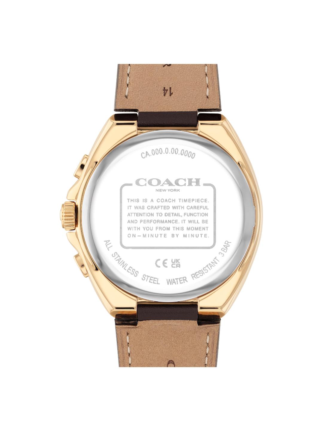 The back view of a Coach New York wristwatch with a gold-tone case and a brown leather strap, showing the detailed specifications printed on the back glass.