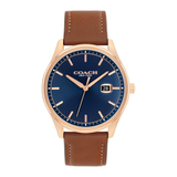 A Coach New York wristwatch with a textured blue dial, rose gold case, and a brown leather strap, shown against a plain white background.