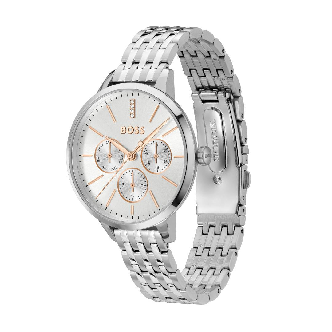 A Hugo Boss women's analog watch with a silver stainless steel link bracelet, a silver case, and a white dial featuring rose gold accents, including the brand name and subdial markers.