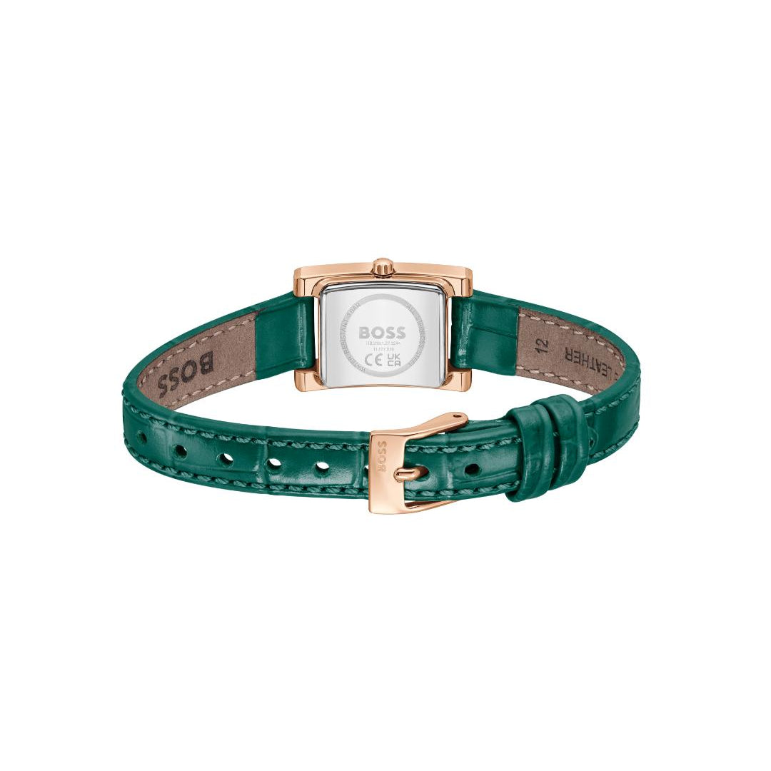 A HUGO BOSS watch with a green leather strap and a rose gold case, shown from the back on a plain white background.