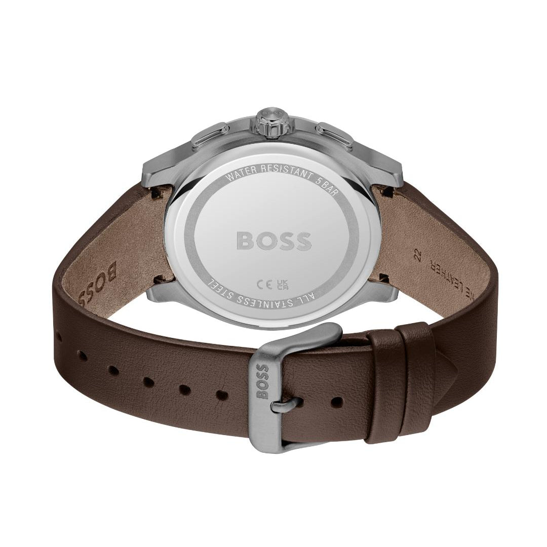 The back view of a BOSS watch with a brown leather strap and a silver stainless steel case, showing the engraved details on the dial.