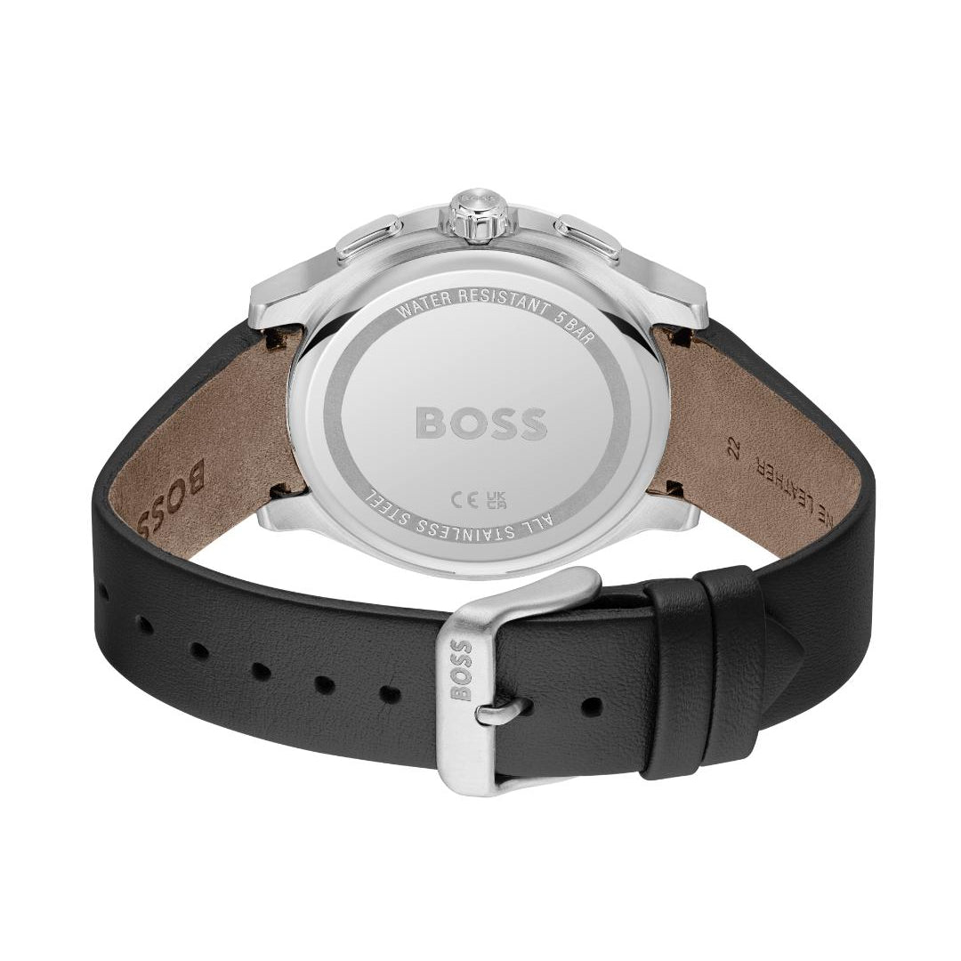 The back view of a BOSS watch with a silver-tone stainless steel case and a black leather strap, showing the brushed metal case back engraved with the BOSS logo.