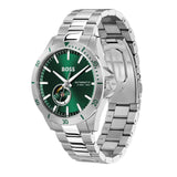A silver stainless steel wristwatch with a green dial and green bezel markings, featuring a silver link bracelet and a visible BOSS logo on the face.