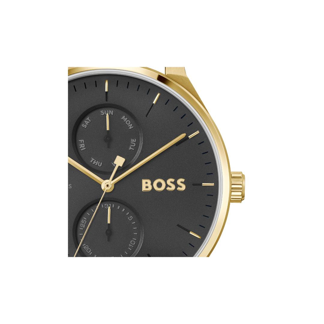 A close-up of a BOSS watch with a black dial, gold-tone case, and gold hands, set against a plain white background.