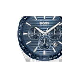 A close-up of a Hugo Boss chronograph watch with a textured blue dial, silver-tone hands and markers, and a dark blue bezel with white tachymeter markings.