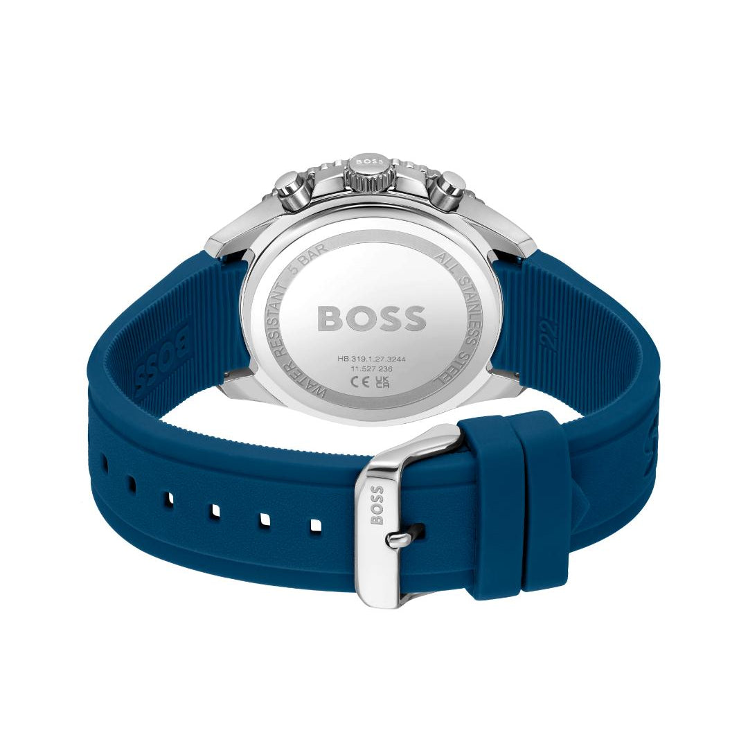 The back view of a HUGO BOSS watch with a blue silicone strap and a silver stainless steel case, showing the branded silver back plate.