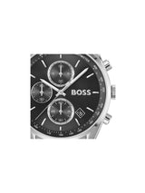 A close-up of a Hugo Boss chronograph watch with a black dial, silver-tone case, and white markings on a plain white background.