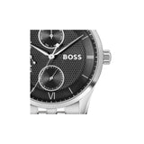 A close-up of a Hugo Boss wristwatch with a textured black dial, silver-tone case, and silver-tone link bracelet on a plain white background.