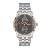 A Hugo Boss men's analog watch with a silver stainless steel link bracelet, a silver case, and a dark gray textured dial featuring rose gold accents, Roman numeral hour markers, and three sub-dials.