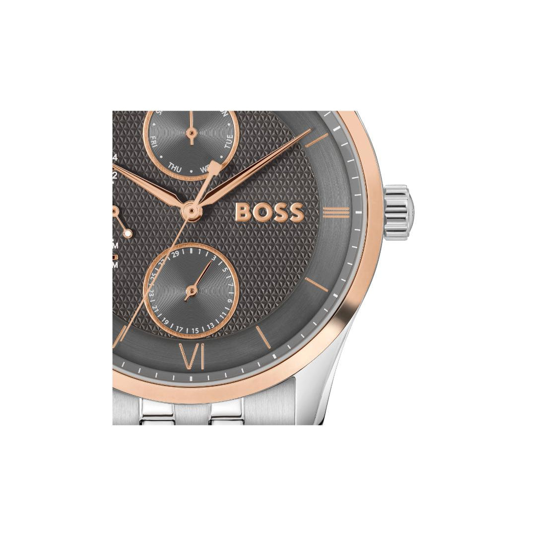 A Hugo Boss wristwatch featuring a textured dark gray dial with rose gold-tone hands, markers, and logo, paired with a silver-tone metal case and link bracelet.
