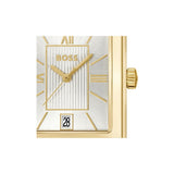 A close-up of a Hugo Boss watch with a textured silver dial, gold-tone case, gold hands, and a date window displaying '28'.