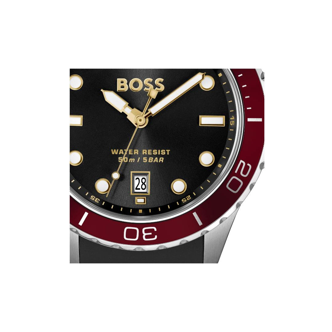 BOSS watch featuring a black dial with gold-tone hands and markers, a date window, and a two-tone red and silver bezel.