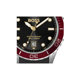 BOSS watch featuring a black dial with gold-tone hands and markers, a date window, and a two-tone red and silver bezel.