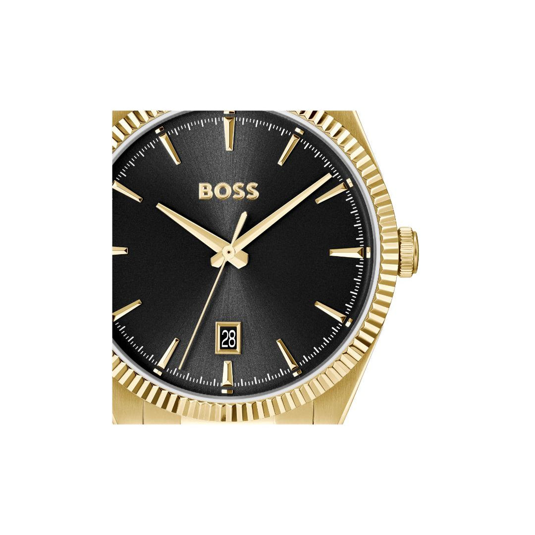 A Hugo Boss men's watch featuring a gold-tone fluted case, a black dial with gold-tone indices and hands, and a date window at the 3 o'clock position.