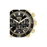 A Hugo Boss wristwatch with a gold-tone case, black dial, and black bezel featuring white markings and a date window.