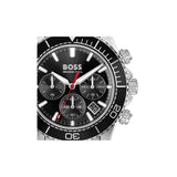 A Hugo Boss wristwatch with a black dial, black bezel, silver-tone case, and a red chronograph second hand, shown against a plain white background.