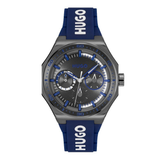 Hugo sport watch with a dark gray octagonal case, dark gray dial with blue accents, and a blue silicone strap with white HUGO branding.