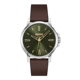 Hugo wristwatch with a dark olive green dial, gold-tone hands and markers, and a brown leather strap, shown on a plain white background.