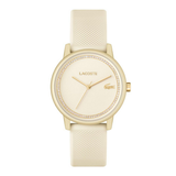 Lacoste watch with a textured cream-colored silicone strap, a gold-tone case, and a matching cream dial accented with a crystal border.