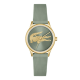 A luxury watch featuring a textured sage green dial and matching green pleated strap, accented by a gold-tone case and the iconic crocodile logo on the dial.
