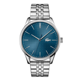 A silver-tone stainless steel wrist watch with a textured blue dial and the iconic green Lacoste crocodile logo at 3 o'clock, set against a plain white background.