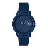 A Lacoste watch with a dark blue textured silicone strap, matching blue round case, and a blue dial featuring the iconic green crocodile logo.