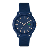 A Lacoste watch with a textured navy blue silicone strap and matching blue dial, featuring rose gold-tone hands and hour markers, and the signature crocodile logo on the dial.