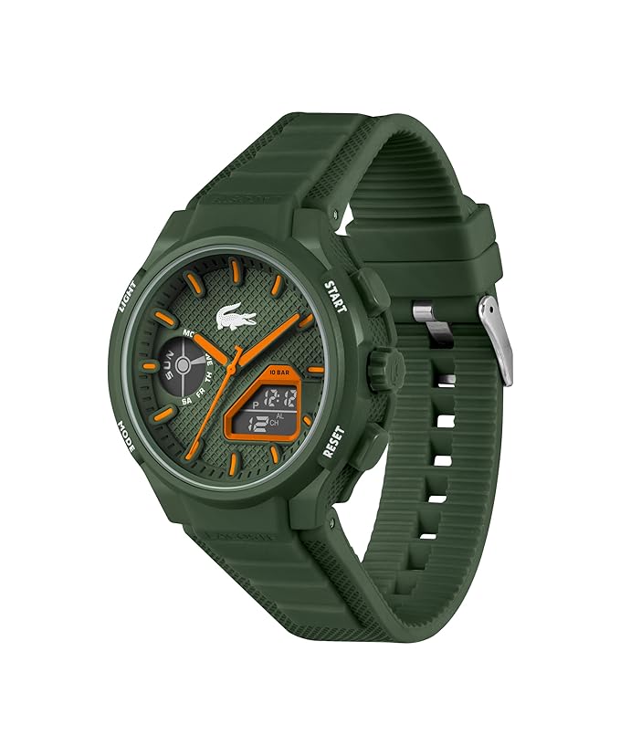 A Lacoste sport watch with an olive green silicone strap, matching green textured dial, and bright orange accents on the hands, markers, and digital display.
