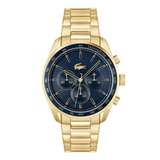 A gold-tone stainless steel chronograph watch by Lacoste with a dark blue dial, featuring three subdials, a crocodile logo on the face, and a matching gold-tone link bracelet, shown against a plain white background.