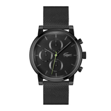 A black chronograph watch with a matching black mesh strap, featuring a black dial with three subdials, a green second hand, and the Lacoste crocodile logo on the face, shown against a plain white background.