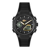 A black Lacoste L-Cosy watch with a textured black strap, black case, and a textured black dial featuring gold-tone hands, white indices, and a small digital display.