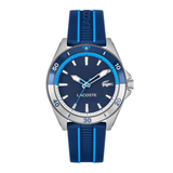 Lacoste men's watch featuring a blue dial, blue bezel, and blue silicone strap with light blue stripes, set against a plain white background.